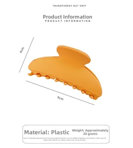 Detail view of a matte orange hair claw clip showing precise 9cm by 4cm product dimensions