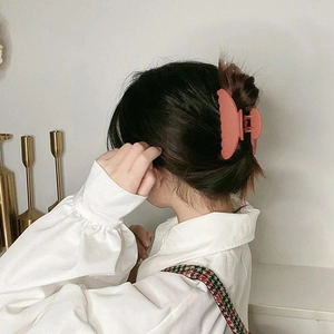 Elegant matte coral pink hair claw clip for women, large geometric design for thick hair styling
