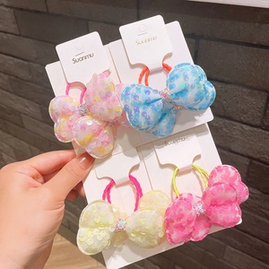 Set di quattro elastici per capelli con fiocchi di paillettes in rosa, blu e giallo
