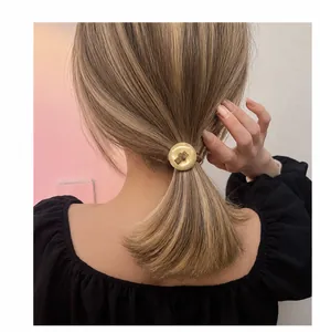 Detail showing elegant button hair tie on high ponytail for daily hairstyling look