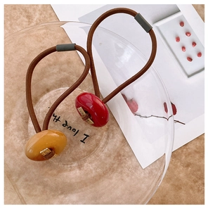 Detail of high-elasticity hair ties with resin beads and gold LOVE metal accents
