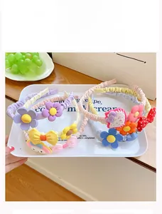 Close-up of kids' flower hairband featuring colorful candy-colored fabric and cartoon resin charms