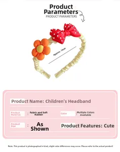 Detail of yellow fabric headband featuring a red polka dot bow and orange flower