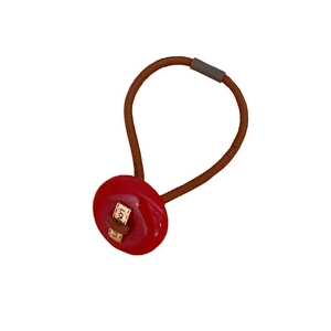 Brown elastic hair tie with red button decor and golden LOVE metal tag for high ponytails