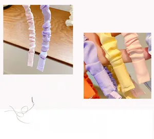 Detailed macro view of colorful scrunched fabric headbands in sweet macaron pastel tones