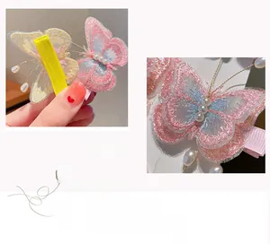 Détail de pince à cheveux papillon en dentelle double couche brodée avec perle et ruban