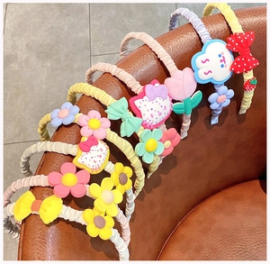 Detailed view of colorful pleated fabric headbands with cute 3D cartoon flower decorations