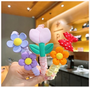 Close-up of colorful floral and bow scrunchies with vibrant silicone flower charms