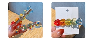 Detailed macro view of colorful candy heart and polka dot resin hair clips on wood