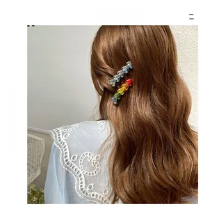 Detail of colorful acrylic beaded hair clips worn on side hair in Korean style