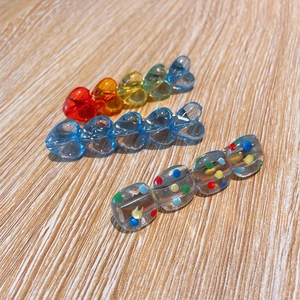 Set of three candy-colored heart and polka dot hair clips in vibrant resin and acrylic