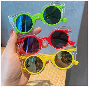 Three colors of kids cat-ear sunglasses with vibrant red, yellow and green frames