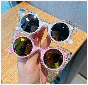Detail of pink and white kids polarized sunglasses with trendy double-layered round frames