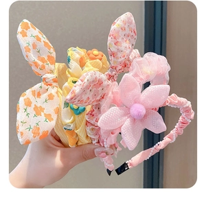 Detailed view of floral cotton rabbit ears headband with lace mesh and pearl trim