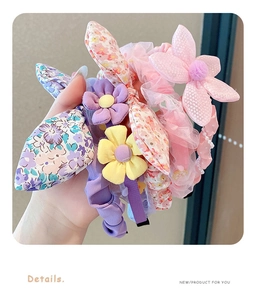 Detail view of floral bow hairbands with soft fabric petals and mesh lace designs