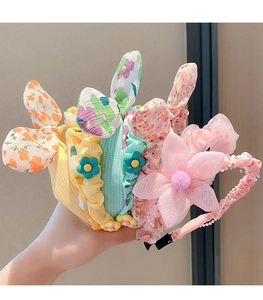 Close-up of floral fabric headbands with bunny ears and pearl mesh flower details
