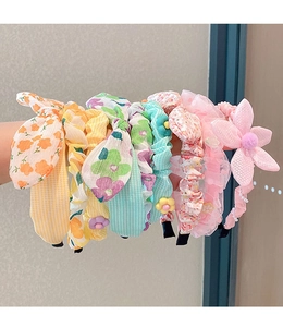 Close-up of assorted floral fabric headbands with lace and mesh details for girls