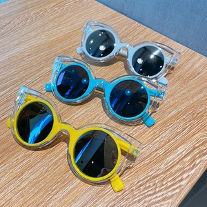 Polarized kids sunglasses featuring a dual-layer cat-eye frame in white, teal, and yellow