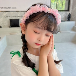 Cute pink floral tulle headband for girls featuring soft plush balls and wavy pleated design