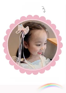 Detail showing non-slip teeth design on pink bow hair clip for girls with long ribbons