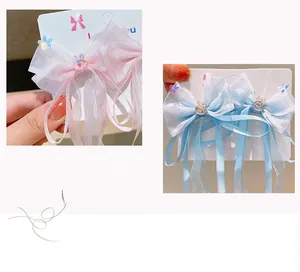Detailed view of chiffon bow hair clips with glitter bunny charms and long ribbons