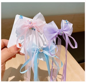 Detailed set of organza bow hair clips with pastel ribbons and rabbit charms on card