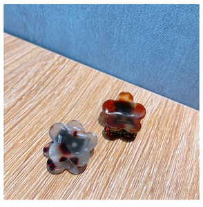 Detail of handmade acetate flower hair claw clips with France Handmade engraving