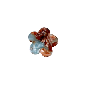 Mini floral hair claw clip with brown marble texture and blue tint on white background