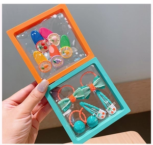 Detailed view of colorful kids hair clips and ties in a 3D floating storage case