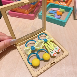 Colorful kids hair accessory set with bow ties and fruit clips in a square gift box