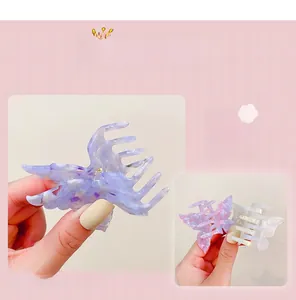 Detail of butterfly hair claw clip with purple marble pattern made of acetic acid