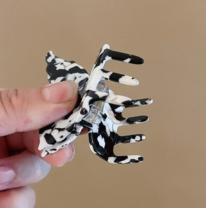 Detail view of the durable metal spring and textured butterfly hair claw clip