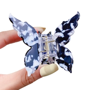 Elegant butterfly hair claw clip with blue marble pattern made of high-quality acetate