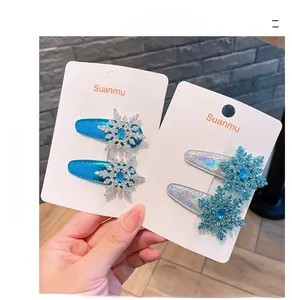 Detail of ice blue princess snowflake hair clips set with silver glitter and gemstones