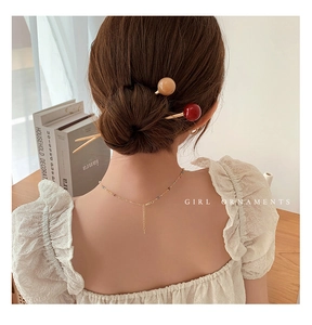 French style coffee glass bead hair pin and gold chain necklace on a model