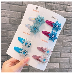 Close-up of glittery snowflake hair clips with colorful jewels in four pastel colors