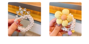 Detail of girl's crown hair tie with pearls and yellow fabric flower hair accessory