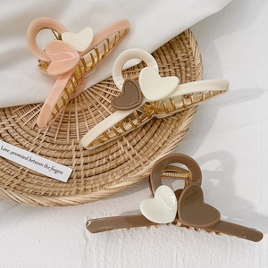 Elegant acrylic heart-shaped hair claw clips in beige and brown colors for women