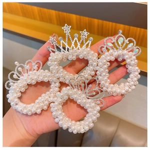 Detailed view of four pearl hair ties with alloy crowns and rhinestones for girls