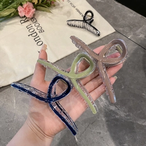 Three jelly color acrylic hair claw clips in navy blue, light green and brown colors