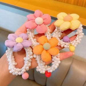 Set of four colorful fabric flower pearl hair ties with crown accents for girls