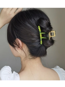 Detailed close-up of a French green acetate hair claw clip styled on a model hair