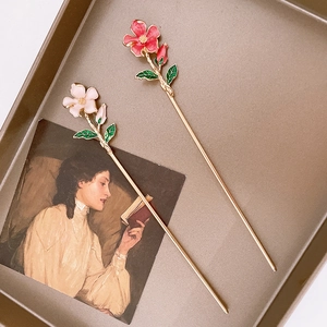 Detailed view of handmade floral hair pins with delicate enamel lily of the valley petals