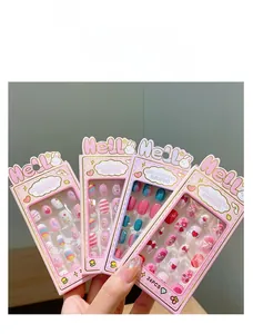 Detailed view of 4-pack kids press-on nail sets with unicorn and rainbow designs