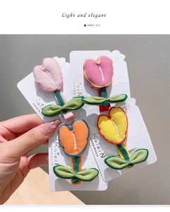 Detailed view of handmade fabric tulip hair clips in various colors for girls