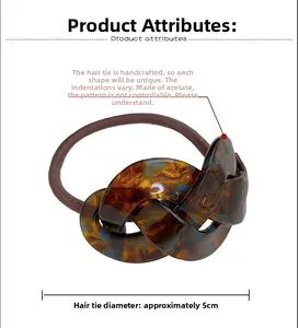 Detail of handmade acetate scrunchie with amber texture and 5cm diameter size