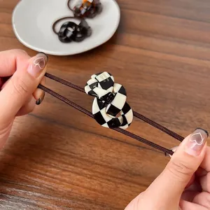 Elastic checkerboard hair tie with durable braided cord and handmade acrylic piece