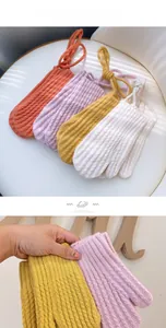 Close-up of four-color knitted winter gloves with hanging rope and corn texture design