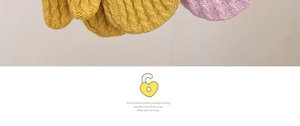Detail of soft knit texture and fine cotton lining in mustard yellow and purple winter gloves