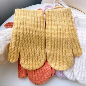 Close-up of thick ribbed knit mittens in vibrant yellow with soft fuzzy texture and hanging cord